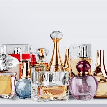Aromatic,Perfume,Bottles,On,White,Wooden,Desk,At,Wooden,Background